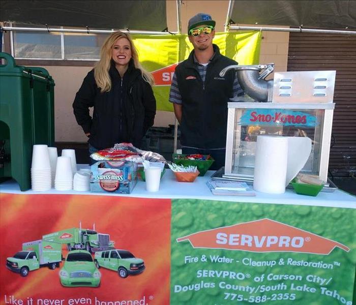 male and female from SERVPRO at the Fire Fest booth.