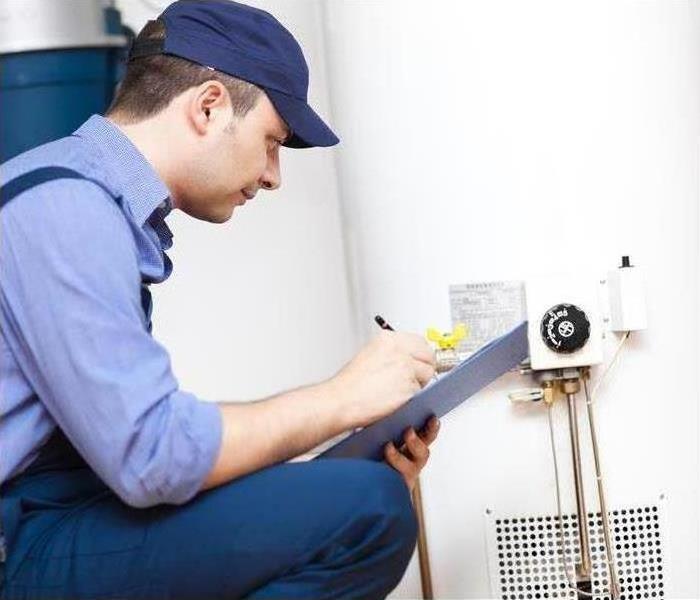 Service man checking water heater